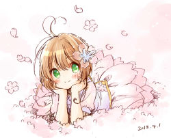 Rule 34 | 1girl, absurdres, ahoge, blush, brown hair, cardcaptor sakura, cherry blossoms, dated, female focus, flower, green eyes, hair flower, hair ornament, hands on own chin, highres, kinomoto sakura, looking at viewer, lying, on stomach, puffy short sleeves, puffy sleeves, short hair, short sleeves, simple background, sketch, smile, solo, uchino maiko