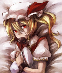 Rule 34 | 1girl, bad id, bad pixiv id, bed, blonde hair, chain, cuffs, embodiment of scarlet devil, female focus, flandre scarlet, hat, hat ribbon, holding, laevatein, looking at viewer, lying, manobana nodoka, manoha (sawayaka-batake), mouth hold, hugging object, on back, pillow, pillow hug, puffy sleeves, red eyes, ribbon, shackles, short hair, short sleeves, side ponytail, solo, touhou