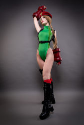 Rule 34 | 1girl, absurdres, argentine (nationality), ass, bare legs, bare shoulders, blonde hair, boots, braid, cammy white, cammy white (cosplay), capcom, cosplay, curvy, fingernails, full body, gloves, green leotard, hat, highleg, highleg leotard, highres, huge ass, leotard, lips, long hair, looking up, photo (medium), real life, shiny clothes, simple background, skindentation, solo, sophie valentine, standing, street fighter, street fighter v, twin braids, very long hair, wide hips