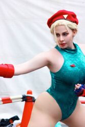 Rule 34 | 1girl, bare legs, bare shoulders, blonde hair, braid, breasts, cammy white, cammy white (cosplay), cosplay, curvy, earrings, fighting stance, fingerless gloves, gloves, hat, highleg, highleg leotard, italian (nationality), jewelry, large breasts, leotard, lips, long hair, photo (medium), real life, revealing clothes, sleeveless, smile, standing, street fighter, thong leotard, twin braids, very long hair, wide hips, yuriko tiger