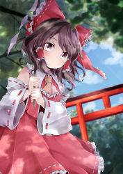 Rule 34 | 1girl, ascot, bare shoulders, black hair, blue sky, blush, bow, brown eyes, cloud, commentary, cowboy shot, day, detached sleeves, forest, frilled ascot, frilled bow, frilled shirt collar, frills, gohei, hair bow, hair tubes, hakurei reimu, highres, holding, kuromame (8gou), long sleeves, looking at viewer, nature, outdoors, petticoat, red bow, red skirt, ribbon-trimmed bow, ribbon-trimmed collar, ribbon-trimmed skirt, ribbon-trimmed sleeves, ribbon trim, short hair, sidelocks, skirt, skirt set, sky, solo, standing, swept bangs, torii, touhou, tree, wide sleeves, yellow ascot