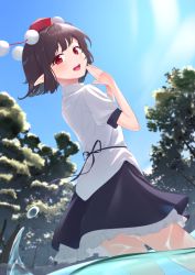 Rule 34 | 1girl, absurdres, black hair, black skirt, blue sky, blush, cloud, commentary request, day, dutch angle, fingernails, from below, from side, hat, highres, kanpa (campagne 9), looking at viewer, looking back, looking down, open mouth, outdoors, own hands together, petticoat, pointy ears, pom pom (clothes), puffy short sleeves, puffy sleeves, red eyes, red hat, shameimaru aya, shirt, short hair, short sleeves, skirt, sky, solo, teeth, tokin hat, touhou, tree, untucked shirt, upper teeth only, wading, water, white shirt, wind, wind lift