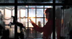 Rule 34 | 1girl, backlighting, blurry, brown hair, building, dark, depth of field, green eyes, hand up, highres, indoors, lens flare, original, outstretched hand, profile, scenery, short hair, sky, solo, sumiobunnya, sunlight, sunset, upper body, window