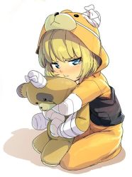 Rule 34 | 1girl, :t, alternate costume, animal costume, animal hood, bandages, bear costume, bear hood, blonde hair, blue eyes, boko (girls und panzer), closed mouth, commentary, from side, frown, girls und panzer, glaring, half-closed eyes, holding, holding stuffed toy, hood, katyusha (girls und panzer), looking at viewer, magenta (atyana), onesie, pajamas, pout, shadow, short hair, simple background, sitting, solo, stuffed animal, stuffed toy, tearing up, teddy bear, white background