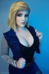 Rule 34 | 1girl, android 18, blonde hair, breasts, cleavage, cosplay, denim skirt, dragon ball, dragonball z, jacket, large breasts, looking at viewer, photo (medium), shirt, skirt, solo