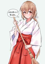 Rule 34 | 1girl, alternate costume, blush, broom, brown eyes, brown hair, grey background, hair between eyes, hair ornament, hairclip, hakama, hakama skirt, highres, holding, holding broom, japanese clothes, kantai collection, komb, long hair, low twintails, miko, red hakama, simple background, skirt, smile, solo, speech bubble, tashkent (kancolle), translation request, twintails