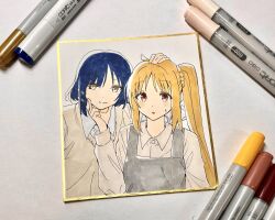 2girls ahoge alternate_costume apron art_tools_in_frame blonde_hair blue_hair blush bocchi_the_rock! brown_cardigan cardigan collared_shirt grey_apron hair_ornament hair_over_one_eye hairpin hand_on_another&#039;s_cheek hand_on_another&#039;s_face hand_on_another&#039;s_head highres ijichi_nijika kanaria_hisagi long_hair long_sleeves looking_at_viewer marker marker_(medium) medium_hair mole mole_under_eye multiple_girls paper parted_bangs parted_lips photo_(medium) red_eyes shirt side_ponytail sidelocks smile sweatdrop sweater_vest traditional_media upper_body white_shirt yamada_ryo yellow_eyes