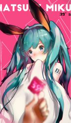 Rule 34 | 1girl, 39, animal ears, blue eyes, blue hair, blurry, blurry foreground, blush, commentary request, condom, condom wrapper, covering own mouth, depth of field, embarrassed, hairband, hatsune miku, holding, holding condom, long hair, openvl, pink background, rabbit ears, solo focus, tattoo, twintails, vocaloid
