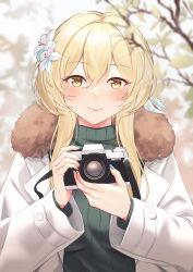 Rule 34 | 1girl, blonde hair, blue nails, blurry, blurry background, blurry foreground, blush, branch, camera, closed mouth, commentary, flower, fur trim, genshin impact, green sweater, hair between eyes, hair flower, hair ornament, highres, holding, holding camera, jacket, kul (ngsensei), leaf, long sleeves, looking at viewer, lumine (genshin impact), nail polish, outdoors, sidelocks, smile, solo, sweater, upper body, white jacket, yellow eyes