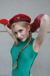 Rule 34 | 1girl, armpits, arms behind head, arms up, braid, breasts, cammy white, cammy white (cosplay), capcom, cosplay, covered erect nipples, crystal graziano, hat, highres, leotard, looking at viewer, medium breasts, photo (medium), street fighter