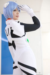 Rule 34 | 1girl, asian, ayanami rei, blue hair, color contacts, cosplay, cowboy shot, hairpods, highres, looking to the side, namada, neon genesis evangelion, photo (medium), plugsuit, red eyes, short hair, solo, standing