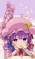 Rule 34 | 1girl, blunt bangs, blush, book, boots, cake, commentary request, crescent moon symbol, crossed legs, double bun, elbow rest, feeding, food, fork, hair bun, hair ribbon, hat, hat ribbon, head in hand, head rest, highres, incoming food, leg lift, long sleeves, looking at viewer, lying, mob cap, on bed, on stomach, open book, open mouth, patchouli knowledge, pink footwear, pink robe, pov, pov feeding, purple background, purple eyes, purple hair, red ribbon, ribbon, robe, shortcake, sidelocks, solo, star (symbol), touhou, tress ribbon, zuttokodomo