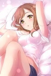 Rule 34 | 1girl, arms behind head, bare arms, bed, blue shorts, blush, breasts, brown hair, highres, kunikida hanamaru, legs, legs up, lens flare, lens flare abuse, long hair, looking at viewer, love live!, love live! sunshine!!, lying, medium breasts, on back, on bed, parted lips, pillow, sekina, shirt, short shorts, shorts, solo, white shirt, yellow eyes