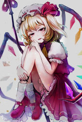 Rule 34 | 1girl, ascot, black nails, blonde hair, bloomers, crystal, fangs, fingernails, flandre scarlet, frills, full body, grey background, hand on own knee, hat, hat ribbon, highres, knees up, laevatein (touhou), mary janes, mob cap, nail polish, puffy short sleeves, puffy sleeves, red eyes, red footwear, red nails, red ribbon, red skirt, red vest, ribbon, sakikomimimmi, shirt, shoes, short sleeves, simple background, sitting, skirt, skirt set, socks, solo, touhou, underwear, vest, white socks, wings