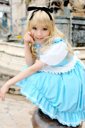 Rule 34 | 1girl, alice (alice in wonderland), alice (alice in wonderland) (cosplay), alice in wonderland, apron, asian, blonde hair, blue eyes, breasts, color contacts, cosplay, hair ribbon, kipi-san, long hair, looking at viewer, mole, petite, photo (medium), pointing, pointing at viewer, ribbon, small breasts, solo, squatting