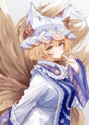 Rule 34 | 1girl, animal hat, blonde hair, blue tabard, blush, breasts, dress, finger to mouth, fox tail, hat, highres, kitsune, kyuubi, lace-trimmed headwear, lace trim, large breasts, looking at viewer, mob cap, multiple tails, sarasadou dan, slit pupils, solo, tabard, tail, touhou, white dress, yakumo ran, yellow eyes
