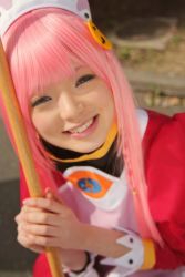 Rule 34 | 1girl, apron, asian, blurry, breasts, broom, color contacts, cosplay, depth of field, dress, highres, looking at viewer, maid, maid apron, makeup, mascara, namada, nono (top wo nerae 2!), outdoors, photo (medium), pink hair, puffy sleeves, sidelocks, sitting, small breasts, smile, solo, top wo nerae 2!
