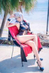 Rule 34 | 1girl, arm up, armpits, azur lane, bare legs, black coat, black one-piece swimsuit, blue footwear, blurry, breasts, buckle, casual one-piece swimsuit, chair, cleavage, closed mouth, coat, unworn coat, cosplay, cosplay photo, crossed legs, day, depth of field, expressionless, full body, fur-trimmed coat, fur trim, graf zeppelin (azur lane), graf zeppelin (azur lane) (cosplay), hair ornament, head tilt, high heels, highres, large breasts, long hair, looking at viewer, ocean, on chair, one-piece swimsuit, palm tree, photo (medium), pink eyes, pink lips, shadow, silver hair, sitting, solo, sunlight, swimsuit, tree, water, wrist cuffs