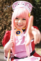 Rule 34 | 1girl, apron, asian, blurry, breasts, broom, cosplay, depth of field, dress, hedge, highres, index finger raised, looking at viewer, maid, maid apron, makeup, mascara, namada, nono (top wo nerae 2!), outdoors, parking lot, photo (medium), pink hair, pointing, pointing at viewer, puffy sleeves, sidelocks, small breasts, smile, solo, top wo nerae 2!