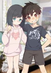 Rule 34 | 1boy, 1girl, absurdres, black hair, black shirt, blue eyes, blurry, blurry background, blush, brown eyes, brown hair, brown shorts, closed mouth, collarbone, commentary request, crossdressing, drawstring, feet out of frame, grin, hand on another&#039;s shoulder, heart, highres, hood, hoodie, lolicom, long sleeves, looking at viewer, nose blush, original, photo background, pink hoodie, print shirt, puffy long sleeves, puffy sleeves, reverse trap, shirt, short hair, short sleeves, shorts, smile, standing, t-shirt, tomboy, trap