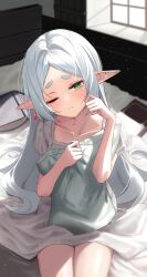 Rule 34 | 1girl, absurdres, book, closed mouth, collarbone, commentary, dress, earrings, elf, frieren, g gonor, green eyes, hands up, hashtag-only commentary, highres, hugging object, indoors, jewelry, light particles, long hair, morning, on bed, one eye closed, pillow, pillow hug, pointy ears, short sleeves, sitting, solo, sousou no frieren, thick eyebrows, waking up, white dress, white hair, window