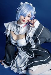 Rule 34 | black dress, blue eyes, blue hair, cosplay, dress, glico happy, highres, looking at viewer, rem (re:zero), rem (re:zero) (cosplay), sitting