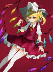 Rule 34 | 1girl, blonde hair, breasts, closed mouth, collared shirt, crystal, feet out of frame, flandre scarlet, frilled skirt, frills, hat, highres, looking at viewer, medium hair, mob cap, multicolored wings, neck ribbon, one side up, psyren2, puffy short sleeves, puffy sleeves, red background, red eyes, red skirt, red vest, ribbon, shirt, short sleeves, simple background, skirt, skirt set, small breasts, solo, thighhighs, touhou, vest, white hat, white shirt, white thighhighs, wings, wrist cuffs, yellow ribbon, zettai ryouiki