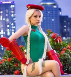 Rule 34 | beke (cosplayer), blonde hair, cammy white, cammy white (cosplay), city, cosplay, flower, hat, leotard, long hair, looking at viewer, night, outdoors, photo (medium), rose, scar, sitting, street fighter, twintails