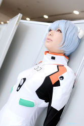 Rule 34 | 1girl, against wall, asian, ayanami rei, blue hair, color contacts, cosplay, dutch angle, hairpods, indoors, leaning back, makeup, mascara, namada, neon genesis evangelion, photo (medium), plugsuit, plugsuit (cosplay), short hair, solo