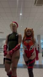 Rule 34 | 2girls, animated, artist request, ass, ass tattoo, bare legs, blonde hair, braid, brazilian (nationality), breasts, cammy white, cammy white (cosplay), cleavage, cleavage cutout, clothing cutout, cosplay, dragon, dragon ball (object), dragon tattoo, eastern dragon, female focus, fingerless gloves, gloves, green leotard, hat, highleg, highleg leotard, hip tattoo, indoors, leg tattoo, leotard, long hair, looking at viewer, looking back, medium breasts, multiple girls, multiple views, neon genesis evangelion, nerokosplayer, official alternate costume, orange hair, photo (medium), plugsuit, red gloves, red leotard, shenron (dragon ball), small breasts, smile, sound, souryuu asuka langley, souryuu asuka langley (cosplay), standing, street fighter, tagme, tattoo, thighs, turnaround, video, wide hips