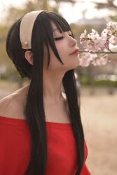 Rule 34 | 1girl, azumilk, black eyeshadow, black hair, blurry, blurry background, brown hairband, cherry blossoms, closed eyes, collarbone, cosplay photo, eyeshadow, flower, from side, hair behind ear, hairband, highres, makeup, off-shoulder sweater, off shoulder, photo (medium), pink flower, red sweater, short hair with long locks, smelling, smile, solo, spy x family, sweater, yor briar