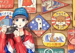 Rule 34 | 1girl, aiming, aiming at viewer, beanie, black hair, blue eyes, blue hat, blue jacket, camera, commentary request, dice earrings, hands up, hat, highres, holding, holding camera, jacket, looking at viewer, multicolored clothes, multicolored jacket, nail polish, open mouth, original, pink nails, raito (latek), red jacket, short hair, sign, solo, taking picture, translation request, upper body, white jacket, wooden wall