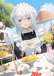 1girl absurdres apron blue_eyes bow bowtie commentary cup cupcake day dessert english_commentary flower food gazebo highres holding holding_cup long_hair long_sleeves looking_at_viewer maid maid_headdress open_mouth original outdoors plate ruruka_003 sky smile solo teacup tiered_tray tree two_side_up white_hair