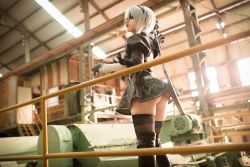 Rule 34 | 1girl, ass, black dress, black hairband, black thighhighs, blindfold, boots, closed mouth, dress, feather-trimmed sleeves, gloves, hair over eyes, hairband, juliet sleeves, katana, long sleeves, mole, mole under mouth, nier, nier:automata, nier (series), photo (medium), puffy sleeves, shiny clothes, short hair, skindentation, solo, sword, thigh boots, thighhighs, vambraces, weapon, white hair, 2b (nier:automata), zettai ryouiki