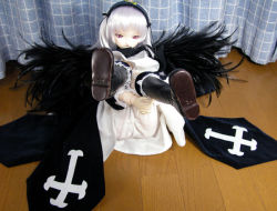 Rule 34 | 00s, 1girl, black wings, bloomers, doll, figure, hairband, lolita hairband, looking at viewer, lying, on back, parted lips, photo (medium), pink eyes, rozen maiden, sakura color, shoe soles, silver hair, smirk, solo, suigintou, underwear, wings