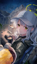 Rule 34 | 1girl, absurdres, blue archive, blush, closed mouth, coffee, coffee mug, cup, food, green eyes, green halo, green jacket, grey hair, halo, hare (blue archive), hare (camp) (blue archive), hat, highres, holding, holding cup, holding food, hood, hood down, hooded jacket, jacket, leehong studio, long hair, long sleeves, mug, night, official alternate costume, outdoors, ponytail, smile, solo, sweet potato, white hat