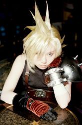 Rule 34 | 1girl, armor, asian, asymmetrical clothes, bare shoulders, black gloves, blonde hair, blue eyes, bracelet, closed mouth, cloud strife, cosplay, cosplay photo, elbow gloves, final fantasy, final fantasy vii, gloves, hair over one eye, hand on own cheek, hand on own face, head rest, jewelry, looking at viewer, photo (medium), shoulder pads, single elbow glove, smile, solo, spiked hair, square enix, star (symbol), suspenders, table, upper body