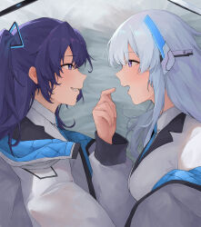 Rule 34 | 2girls, absurdres, bed sheet, blue archive, blush, breasts, eye contact, facing another, grey hair, halo, highres, inakanoinonaka, jacket, jacket partially removed, long sleeves, looking at another, lying, medium breasts, multicolored clothes, multicolored jacket, multiple girls, noa (blue archive), on side, profile, purple eyes, purple hair, smile, two-tone jacket, yuuka (blue archive)