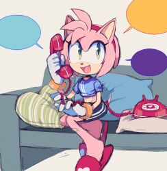 Rule 34 | 1girl, :d, amy rose, blue shirt, calling, couch, furry, furry female, gloves, green eyes, hairband, looking up, motobug, open mouth, phone, pillow, red hairband, shirt, shorts, sitting, smile, solo, sonic (series), speech bubble, white gloves