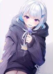 Rule 34 | 1girl, absurdres, black hoodie, blue hair, blush, broken heart, candy, character name, clothes writing, commentary, earphones, ears visible through hair, eating, food, gradient background, grey background, hair ornament, hairclip, heart, highres, holding, holding food, hood, hood down, hoodie, lize helesta, lollipop, long hair, long sleeves, looking at viewer, low twintails, mouth hold, multicolored hair, nijisanji, purple eyes, silver hair, sitting, sleeves past wrists, solo, symbol-only commentary, twintails, twitter username, two-tone hair, virtual youtuber, yunmi 0527