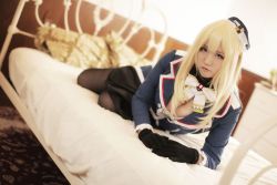 Rule 34 | 1girl, asian, atago (kancolle) (cosplay), atago (kancolle), bed, blonde hair, bow, bowtie, breasts, cleavage, cosplay, gloves, hat, kantai collection, long hair, looking at viewer, lying, mature female, pantyhose, photo (medium), solo, uniform