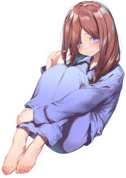 1girl absurdres barefoot blue_eyes blue_pajamas blue_pants blue_shirt blush brown_hair closed_mouth commentary_request full_body go-toubun_no_hanayome hachiroku_(hatirokusann86) highres hugging_own_legs long_hair long_sleeves nakano_miku pajamas pants playing_with_own_hair shirt simple_background solo toes white_background