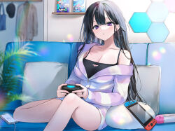 Rule 34 | 1girl, :o, bare shoulders, black hair, blue camisole, blush, breasts, camisole, cleavage, collarbone, controller, couch, highres, holding, holding controller, indoors, jacket, large breasts, long hair, long sleeves, looking at viewer, nekoyashiki pushio, nintendo switch, non-web source, off shoulder, original, parted lips, pillow, plant, purple eyes, short shorts, shorts, sitting, solo, spaghetti strap, white jacket
