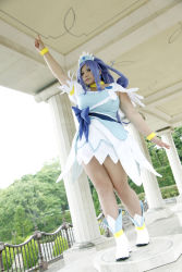 Rule 34 | 1girl, ankle boots, arm up, asian, blue eyes, blue hair, boots, bow, bracelet, breasts, choker, chouzuki maryou, cosplay, cure diamond, cure diamond (cosplay), dokidoki! precure, dress, headpiece, highres, jewelry, large breasts, long hair, magical girl, matching hair/eyes, photo (medium), plump, pointing, ponytail, precure, puffy short sleeves, puffy sleeves, ribbon, short sleeves, solo, tiara