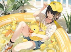 1girl brown_eyes brown_hair fishnet_socks fishnets motto_(night_wear) one_eye_closed partially_submerged rubber_duck shirt shorts sitting socks t-shirt water water_gun