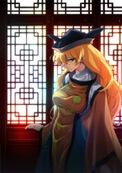 Rule 34 | 1girl, black hat, blonde hair, blouse, breasts, brown eyes, brown hat, commentary request, futoumeido, green skirt, hair between eyes, hat, indoors, large breasts, light particles, long hair, long sleeves, looking at viewer, matara okina, multicolored clothes, multicolored hat, profile, shirt, skirt, solo, standing, tabard, touhou, white shirt, wide sleeves, window