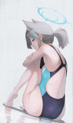 Rule 34 | 1girl, absurdres, alternate hairstyle, animal ear fluff, animal ears, back, back focus, bare legs, barefoot, black one-piece swimsuit, blue archive, blue eyes, blue one-piece swimsuit, commentary, competition swimsuit, crossed arms, dutch angle, from behind, grey hair, halo, highleg, highres, knees to chest, light blush, looking at viewer, multicolored clothes, multicolored swimsuit, official alternate costume, one-piece swimsuit, ponytail, shiroko (blue archive), shiroko (swimsuit) (blue archive), shoulder blades, simple background, solo, swimsuit, white background, wolf ears, yako mashiro