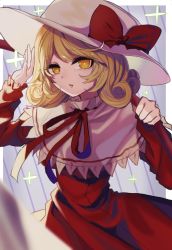 Rule 34 | 1girl, blonde hair, blurry, blurry foreground, border, bright pupils, capelet, commentary request, cowboy shot, curly hair, depth of field, dress, elly (touhou), hand up, hat, hat ribbon, highres, holding, holding scythe, ishikawa sparerib, juliet sleeves, long sleeves, looking at viewer, medium hair, neck ribbon, outside border, parted lips, puffy sleeves, red dress, red ribbon, ribbon, scythe, solo, standing, touhou, touhou (pc-98), white border, white hat, yellow eyes