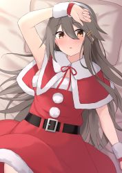 Rule 34 | 1girl, akahi242, bed sheet, belt, belt buckle, black belt, black hair, blush, brown eyes, buckle, capelet, hair between eyes, hair ornament, hairband, hairclip, haruna (kancolle), highres, kantai collection, long hair, open mouth, pillow, pom pom (clothes), red capelet, santa costume, solo, white hairband, wrist cuffs