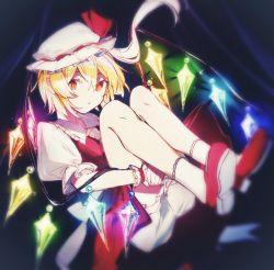 Rule 34 | 1girl, asymmetrical hair, bare legs, blonde hair, bloomers, commentary, crystal, flandre scarlet, frilled cuffs, frilled shirt collar, frilled sleeves, frills, full body, glowing, glowing wings, hat, hat ribbon, holding legs, ikasoba, knees to chest, knees up, looking at viewer, medium hair, mob cap, one side up, orange eyes, own hands together, parted lips, puffy short sleeves, puffy sleeves, red footwear, red ribbon, red skirt, red vest, ribbon, shirt, shoes, short sleeves, side ponytail, skirt, skirt set, socks, solo, touhou, underwear, vest, white bloomers, white hat, white shirt, white socks, wings, wrist cuffs